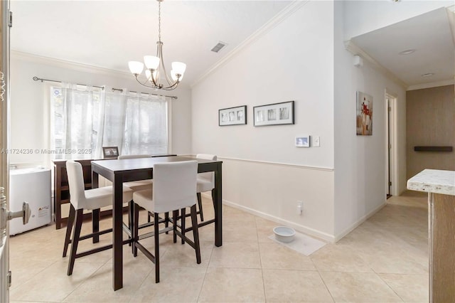 dining area featuring vaulted ceiling, an inviting chandelier, light tile patterned floors, and crown molding