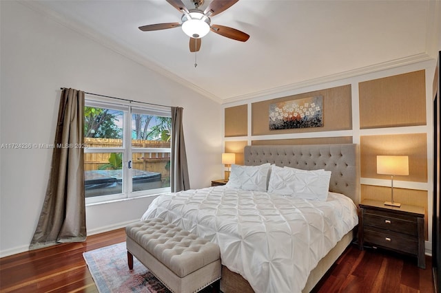 bedroom featuring ceiling fan, dark hardwood / wood-style floors, ornamental molding, and vaulted ceiling