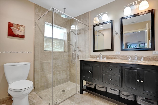 bathroom with toilet, vanity, and an enclosed shower