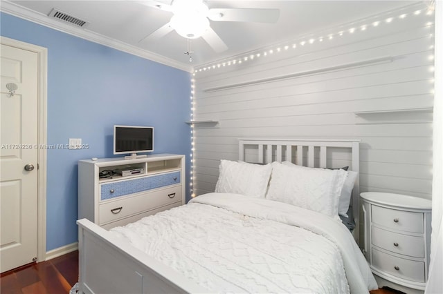 bedroom with dark wood-type flooring, ceiling fan, and ornamental molding