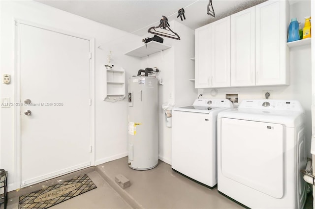 clothes washing area with water heater, separate washer and dryer, and cabinets