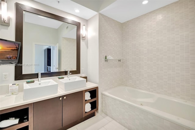 bathroom with vanity, tile patterned floors, and tiled bath