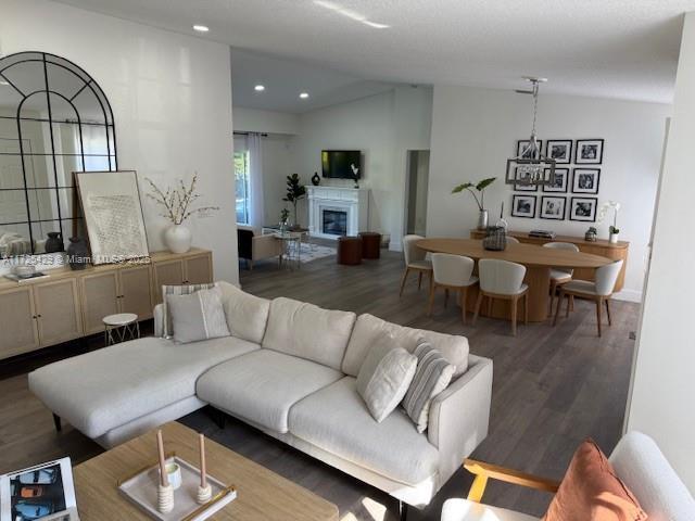 living room featuring dark hardwood / wood-style flooring and lofted ceiling