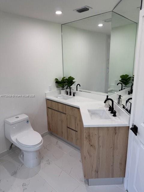 bathroom featuring vanity and toilet