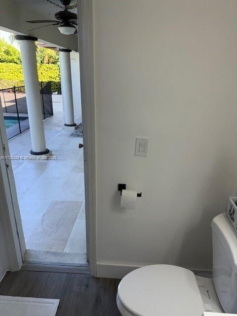 bathroom with toilet, hardwood / wood-style flooring, and ceiling fan