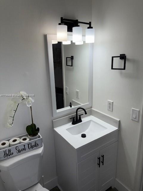 bathroom featuring toilet and vanity