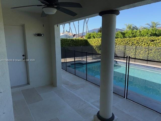 view of swimming pool featuring a patio and ceiling fan