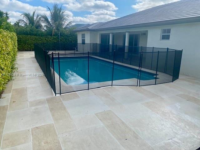 view of swimming pool featuring a patio area