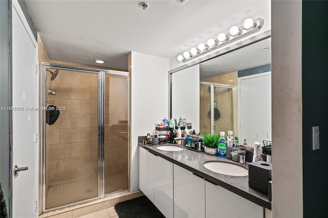 bathroom featuring vanity, tile patterned flooring, and walk in shower