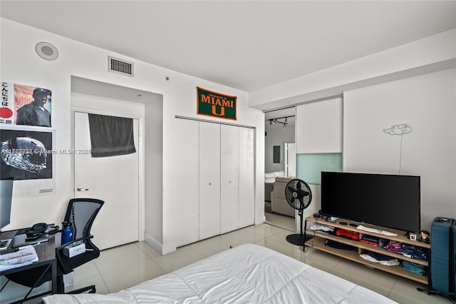 bedroom with a closet and light tile patterned flooring