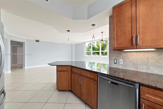 kitchen featuring kitchen peninsula, dark stone counters, decorative light fixtures, stainless steel dishwasher, and light tile patterned flooring