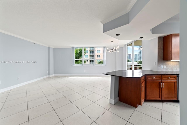 kitchen with decorative light fixtures, ornamental molding, light tile patterned floors, tasteful backsplash, and a chandelier