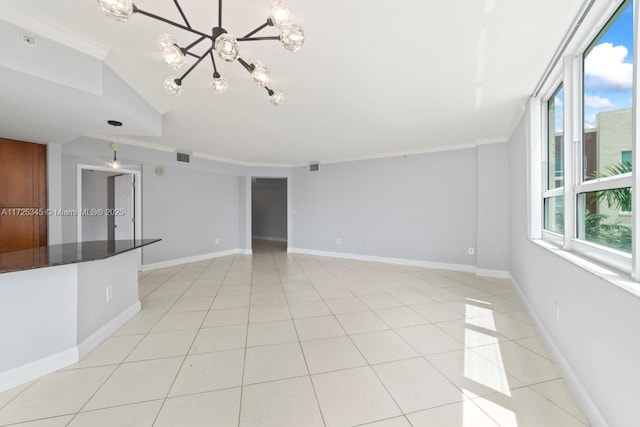 tiled empty room featuring an inviting chandelier and crown molding