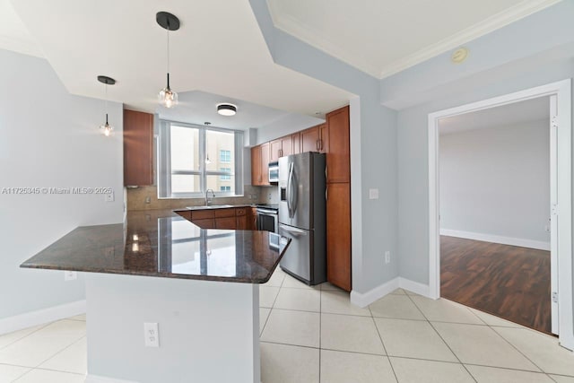 kitchen featuring stainless steel appliances, light tile patterned flooring, and pendant lighting