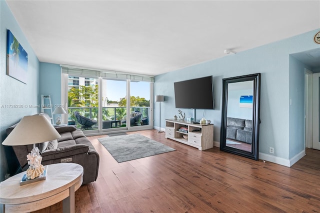 living room featuring floor to ceiling windows and dark hardwood / wood-style flooring