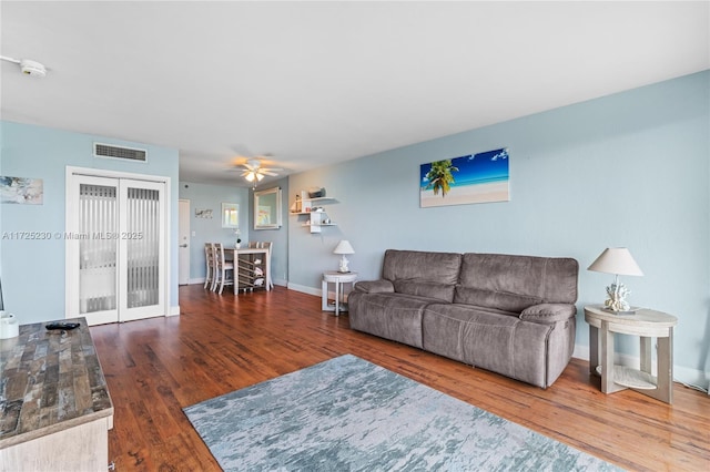 living room featuring ceiling fan and wood-type flooring