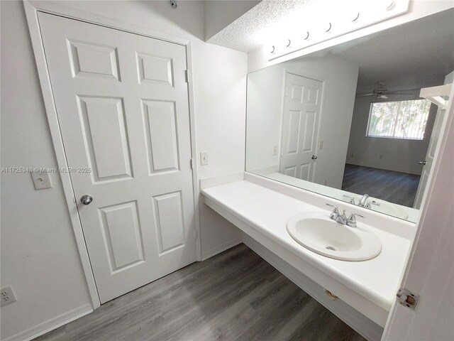 bathroom with hardwood / wood-style flooring, sink, and ceiling fan