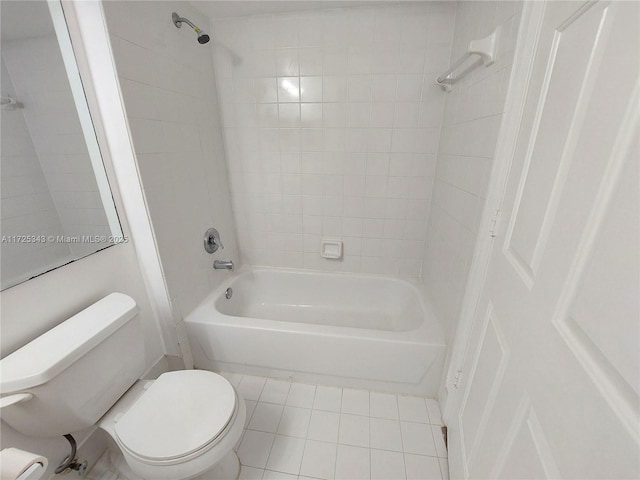 bathroom featuring tile patterned flooring, bathtub / shower combination, and toilet