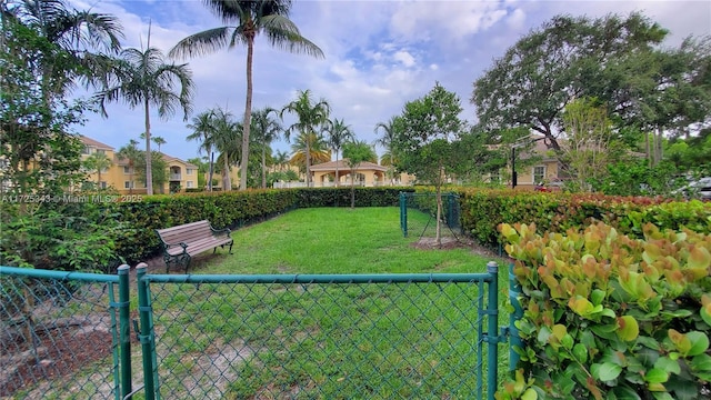 view of yard with fence and a gate