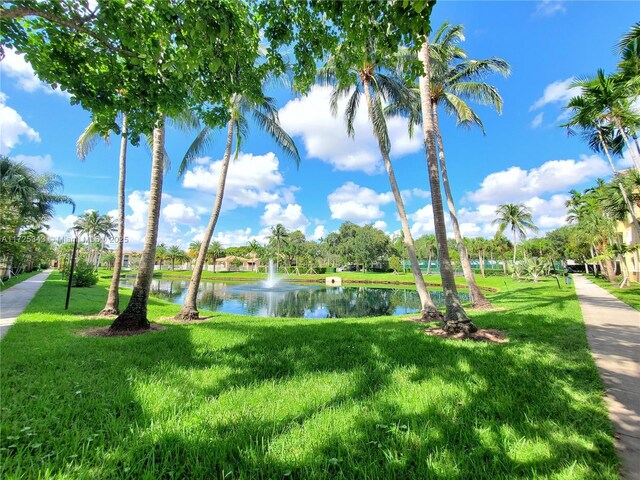 exterior space with a water view and a yard