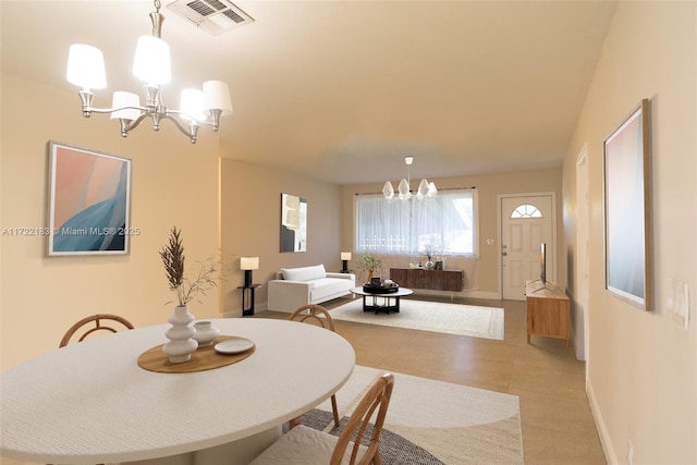 dining area featuring an inviting chandelier