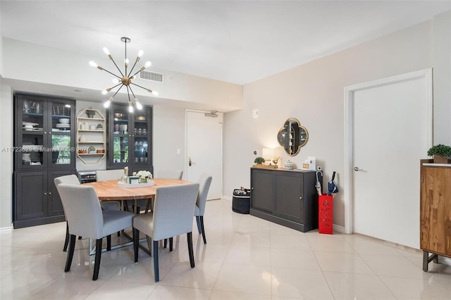 tiled dining room with an inviting chandelier