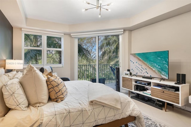 bedroom with multiple windows, access to exterior, and an inviting chandelier