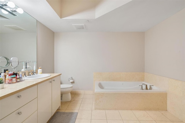 bathroom with toilet, tiled bath, tile patterned floors, and vanity