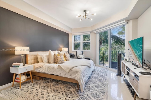 bedroom with access to outside and a notable chandelier