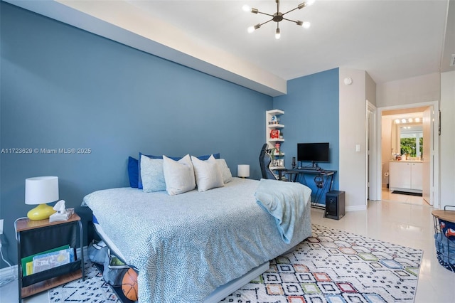 bedroom featuring a notable chandelier and ensuite bathroom