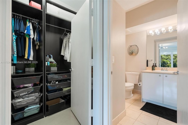 bathroom featuring toilet, vanity, and tile patterned floors