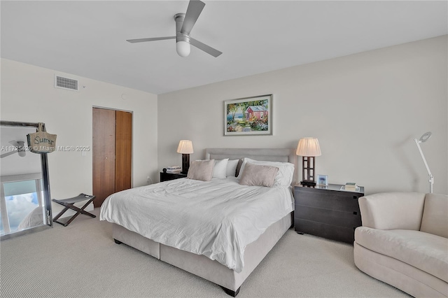 bedroom featuring ceiling fan, a closet, and light carpet