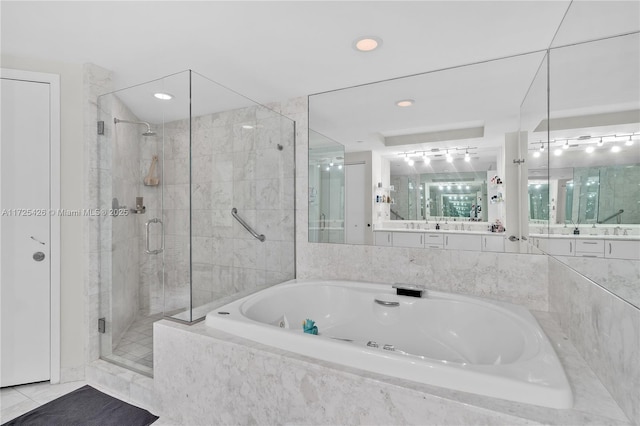 bathroom with sink, tile patterned flooring, and plus walk in shower