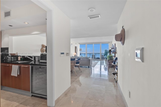 hallway featuring sink and beverage cooler