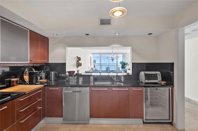 kitchen featuring beverage cooler, a chandelier, dark stone counters, sink, and stainless steel dishwasher