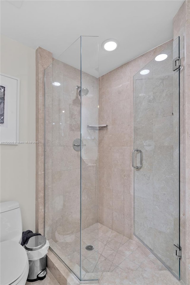 bathroom with toilet and walk in shower