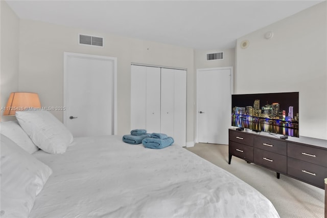 bedroom with a closet and light carpet