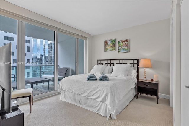 carpeted bedroom featuring access to outside