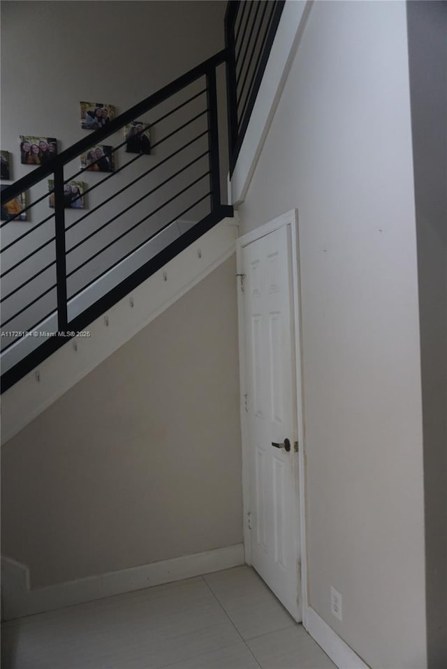 stairway with tile patterned flooring