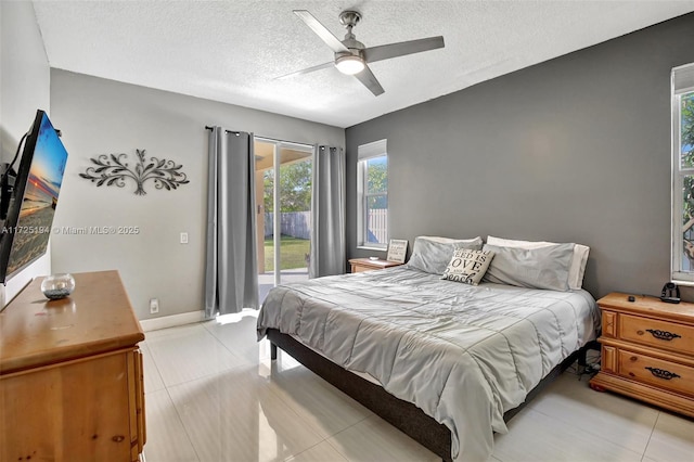 tiled bedroom featuring ceiling fan, access to exterior, and a textured ceiling