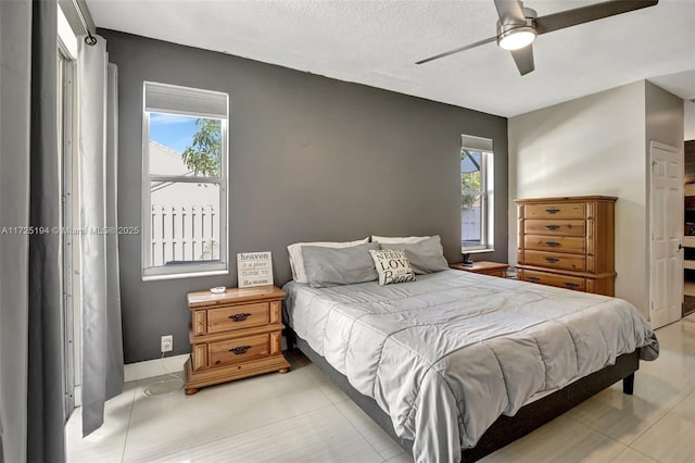 bedroom featuring multiple windows and ceiling fan