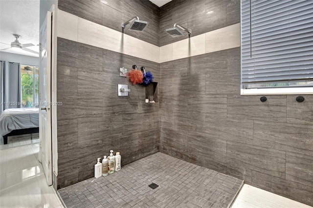 bathroom with ceiling fan and a tile shower