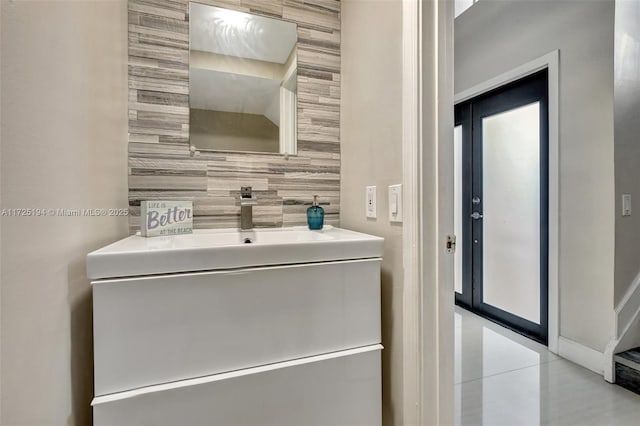 bathroom with vanity, tile patterned flooring, and tile walls