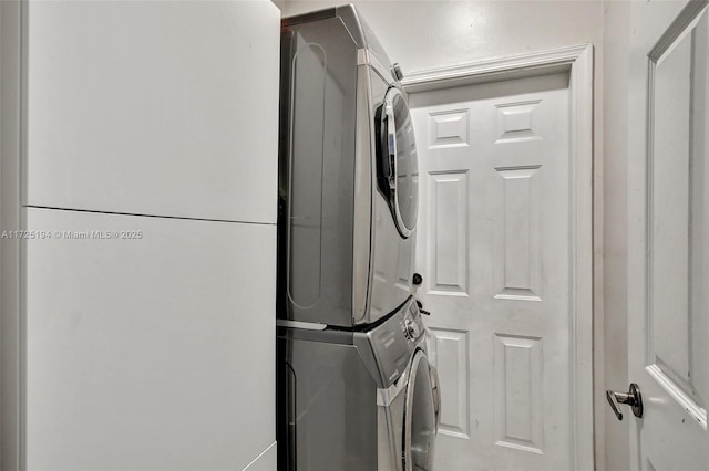 laundry area featuring stacked washer / dryer