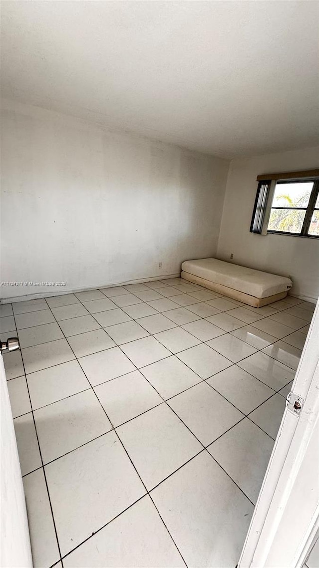 empty room featuring light tile patterned floors