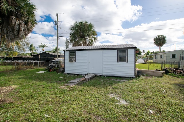 view of outdoor structure featuring a yard and cooling unit