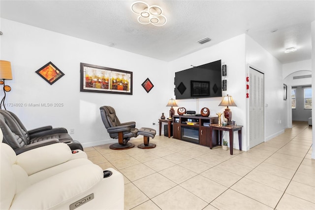 living room with light tile patterned floors and a textured ceiling