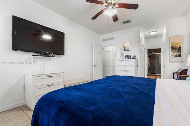 tiled bedroom featuring ceiling fan