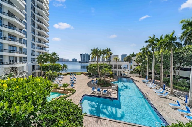 view of pool featuring a patio and a water view