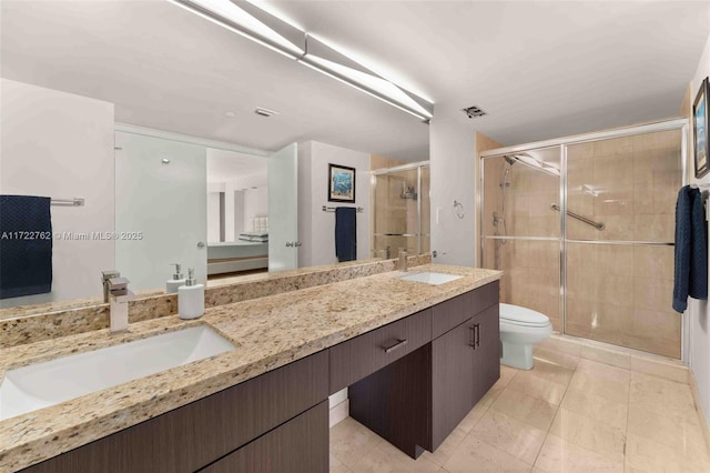 bathroom featuring toilet, an enclosed shower, vanity, and tile patterned floors